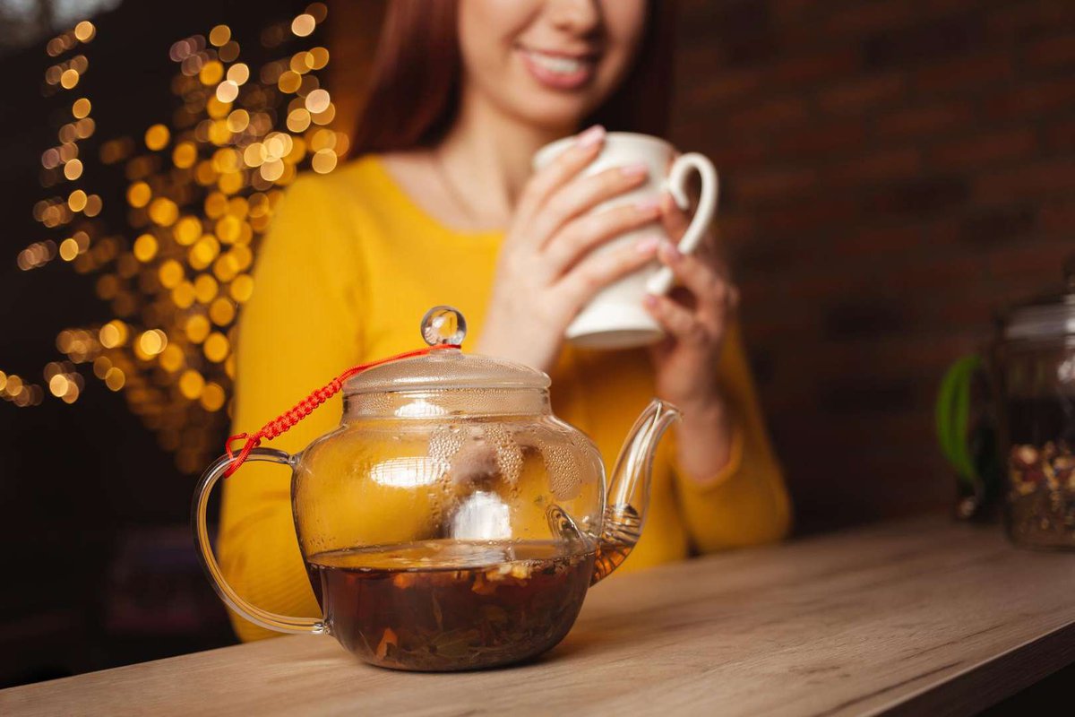 A girl drinks freshly brewed tea in a cafe